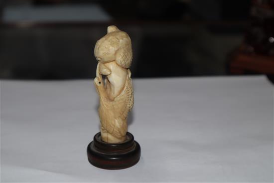 A Japanese ivory cane handle, a faux amber lion-dog and an enamel and ivory pill box